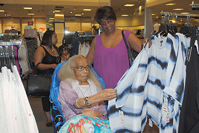 Tempie Williams' daughter, Rene, helps her mother select a few blouses.